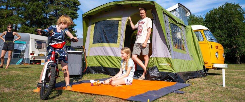 Family camping at Rendlesham Campsite with green tent