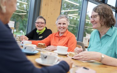 Three customers smiling inside Delamere Forest cafe