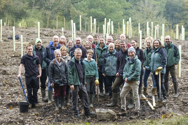 Group of Forestry England staff stood smiling at tree planting event
