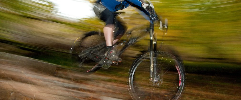 Man mountain biking at speed