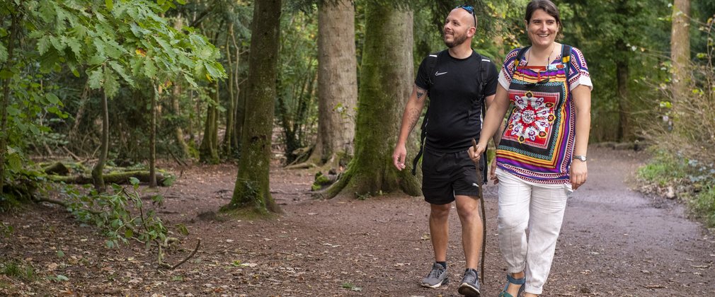 Couple walking on a forest trail