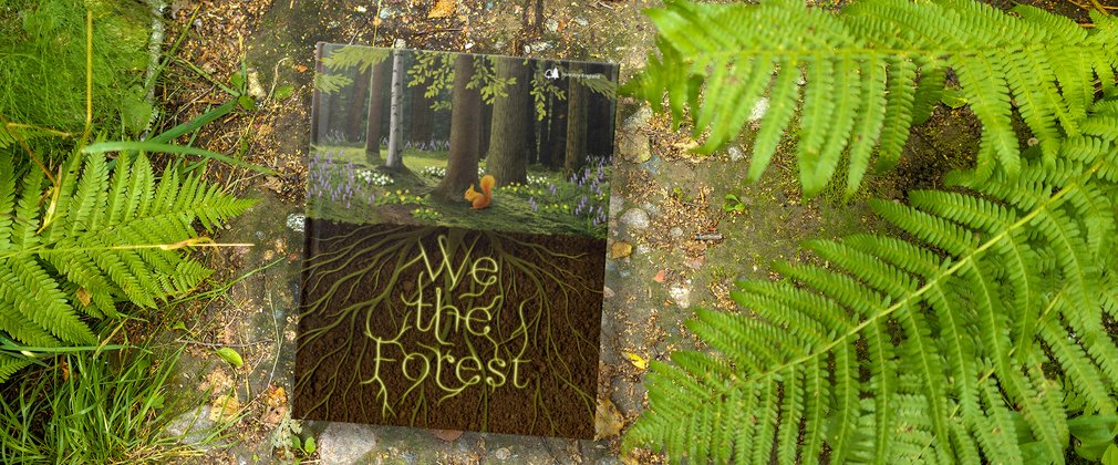 We The Forest book in a forest setting