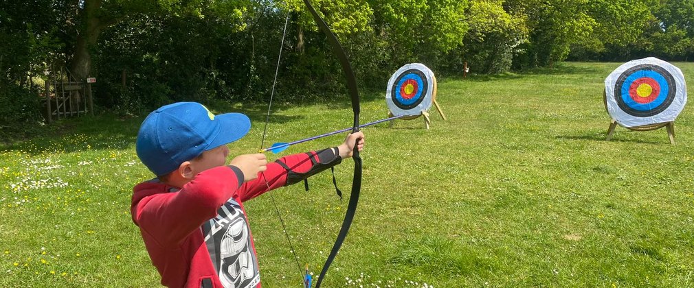 A child taking part in an archery activity