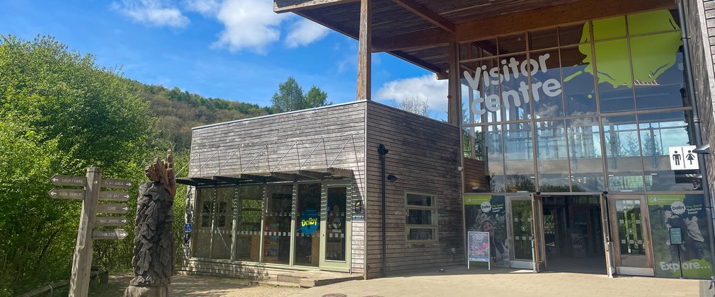 A Visitor Centre building made out of wood with a large glass frontage.
