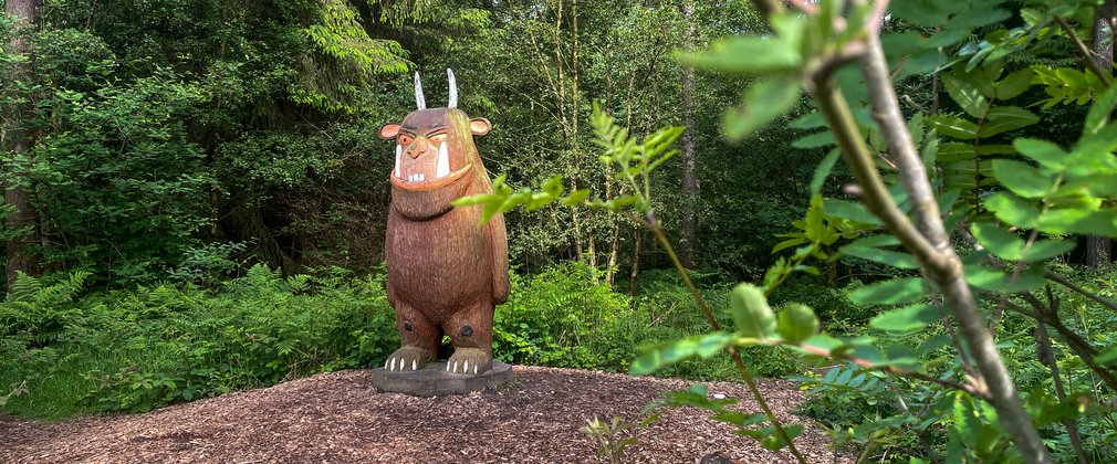 A sculpture of the Gruffalo in the forest