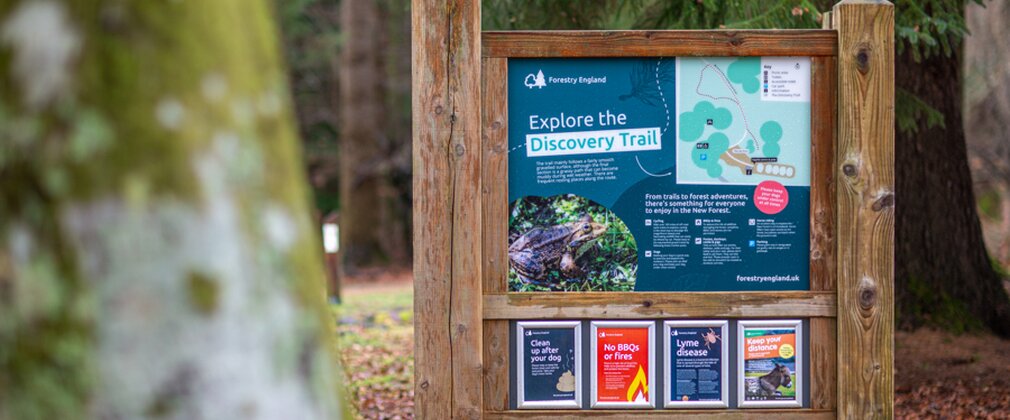 Timber frame signage in forest setting