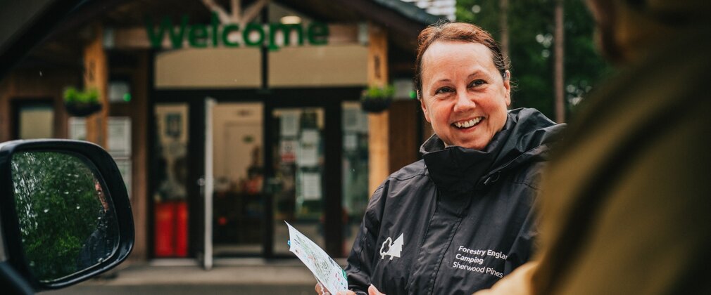 Staff welcoming a campervan at Sherwood Pines Camping