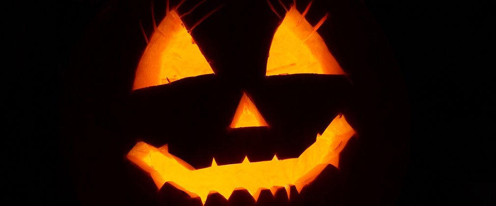 Spooky Halloween pumpkin lit up in the dark