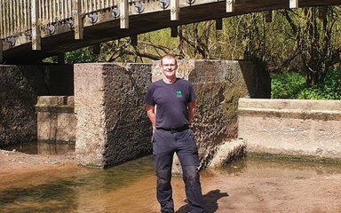 Man standing by a bridge