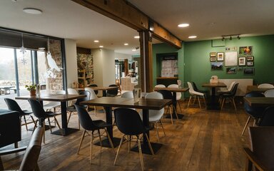 Interior of Beechenhurst cafe showing tables and chairs in front of a large window.