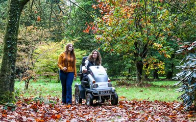 A family enjoying Autumn colours at Cryil Hart Arborteum including Tramper mobility scooter use