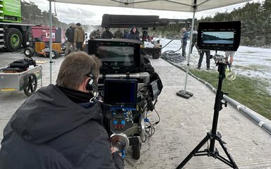 view from behind cameras on a film set in a forest