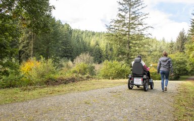 Walker and Tramper user at Cardinham Woods walking away from camera