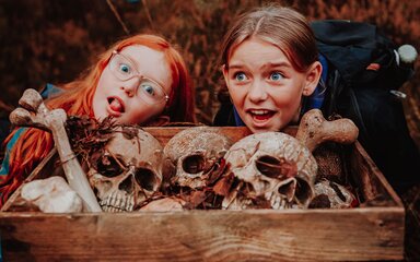 Children in front of skulls at the Halloween trail at Moors Valley