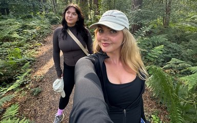 A selfie of two women on a forest path wearing active wear.