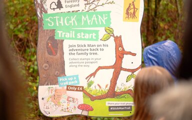 A branded Stick Man panel in the forest