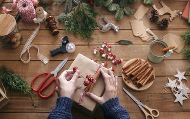 Wrapping a christmas present with decorations 