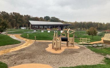 Hicks Lodge cafe building in the background with the playground in the foreground