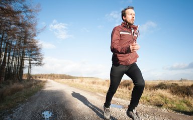 Runner on forest road in Stainburn Forest