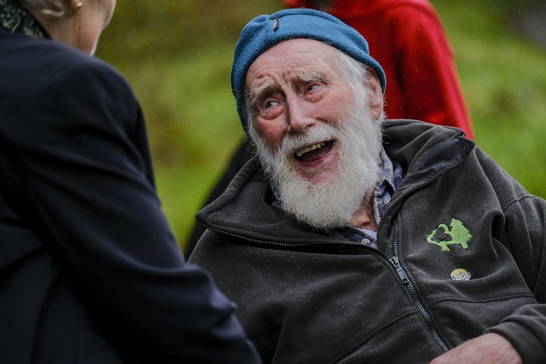 Man smiling while talking to woman