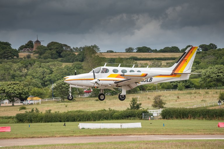 Small aircraft landing in the countryside